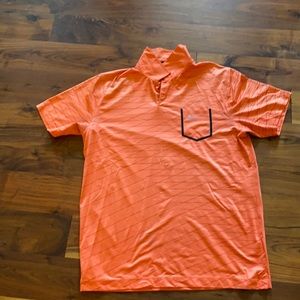 Orange Nike golf shirt.